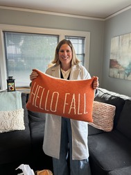 CM Rumbaugh holding a fall pillow