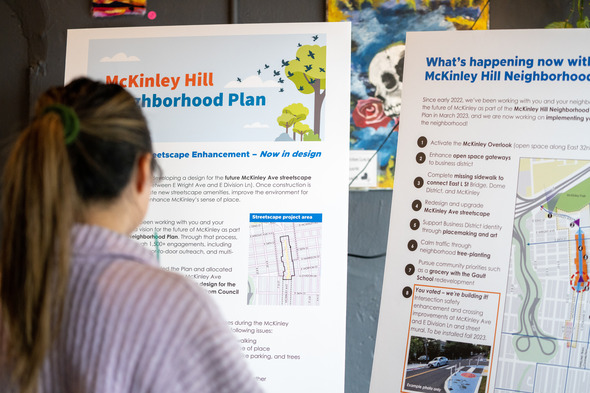 Person at McKinley planning outreach event looking at posters