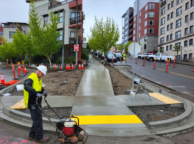 Construction worker working on pedestrian infrastructure. 
