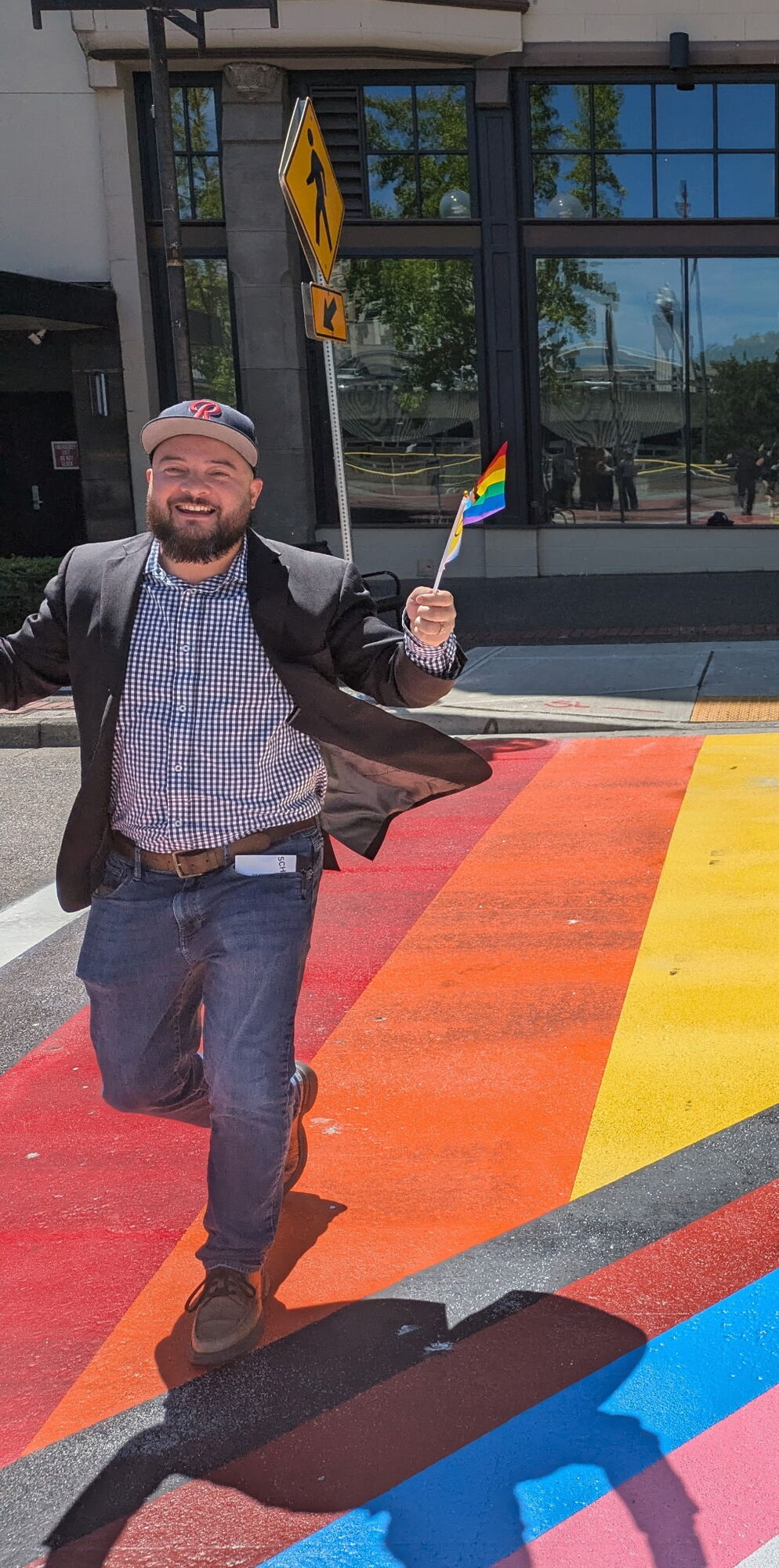 CM Bushnell running across the City's new pride crosswalk 