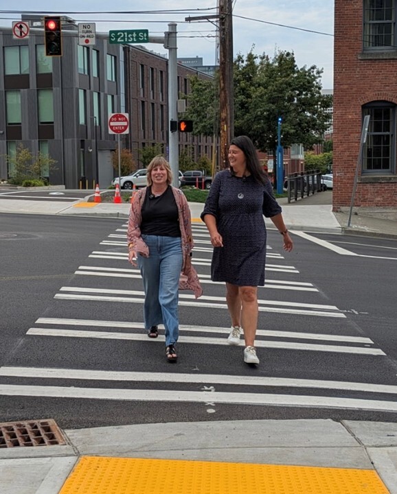 CM Rumbaugh and CM Walker walking across the new crosswalk