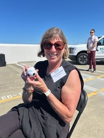 CM Rumbaugh holding a celebratory miniature soccer ball 