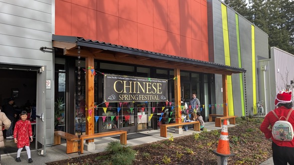 Asia Pacific Cultural Center with Chinese Spring Festival sign and attendees 