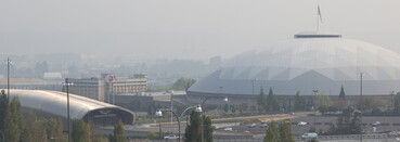Tacoma Dome and LeMay Car Museum blurred by wildfire smoke.