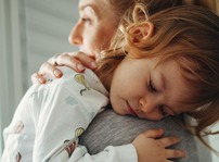 Mom with daughter on shoulder