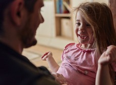Happy little girl looking at her dad.