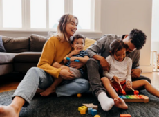 Happy family sitting together in a living area.