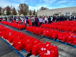 Food-filled red bags filled lined up on a parking lot.