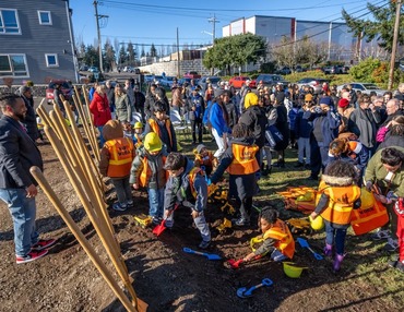 Gathering of people and shovels in the ground.