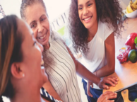 Three generations of women smiling.