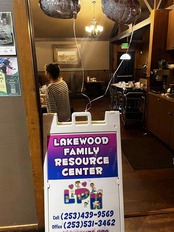 Sandwich board sign "Lakewood Family Resource Center" in door way.
