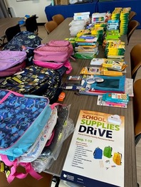 A variety of school supplies spread out on a table.