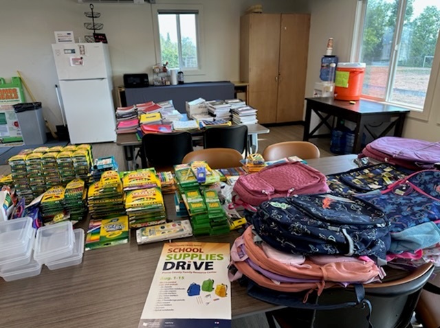 A variety of school supplies spread out on a table.