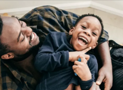 Happy father and young son playing.