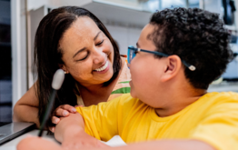 Woman smiling at child.