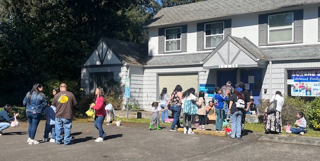 Groups of people gathered in the parking lot of the Lorene's Place II building.