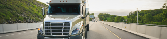 A semi truck driving down the road