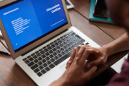 Laptop displaying a blue screen that reads "discussion outline"