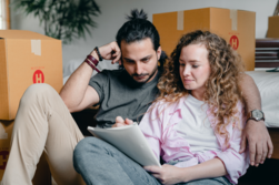 Man and woman sitting on couch reviewing paperwork
