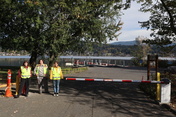Three AIS staff standing next to the new check gate at Bloedel Donovan
