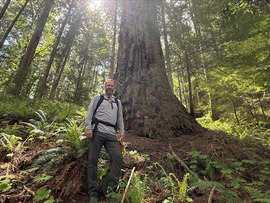 Councilmember Scanlon poses in front of a tree on a hike in the Upper Rutsatz