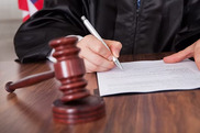 prosecutorial diversion graphic showing a judge signing paperwork