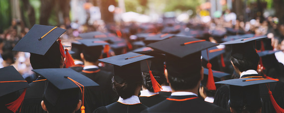 Group of graduates with caps facing away
