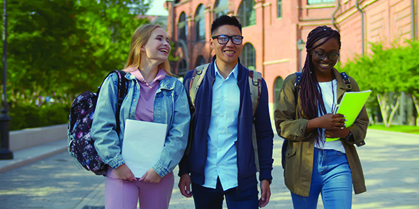 Three students in conversation on a college campus