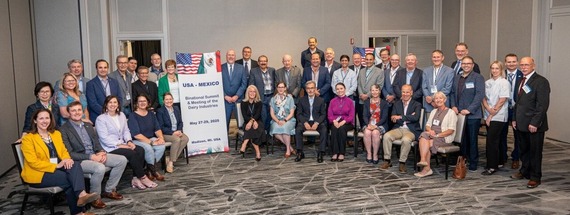 Group of people sitting and standing in semicircle.