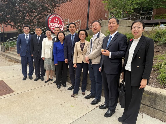 China sister state delegation guests standing in front of Center for Dairy Research, eating ice cream.