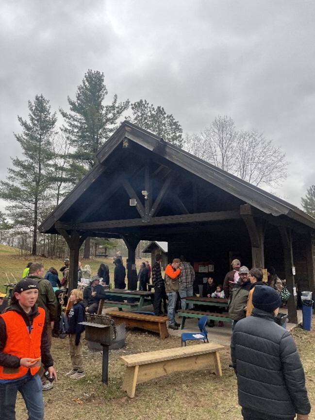 people gathered around a park structure outdoors