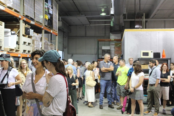 People smiling and chatting in a warehouse