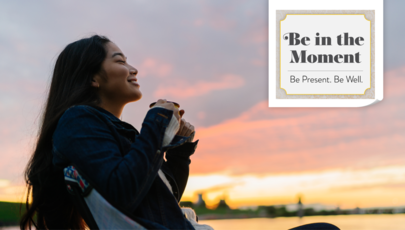 Woman smiling in the sun with the "Be in the Moment. Be Present. Be well." tagline