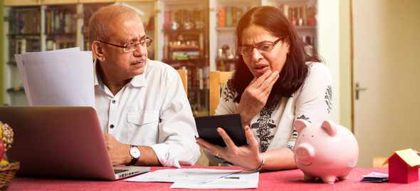 Couple looking bewildered while checking devices