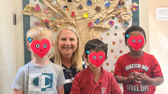 Marianne Rauls with three kids (faces deidentified) at the community center.