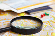 A magnifying glass over a map.