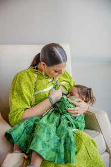 mom breastfeeding in traditional clothing