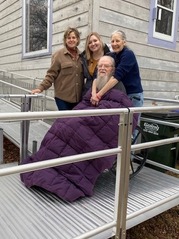 Two Accessibility Assessment Specialists/Modification Navigators with Options for Independent Living Stand Beside Ricki and William On Their New Ramp