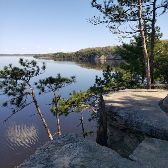 Picture of rocky bluff, pine trees and Wisconsin River in background