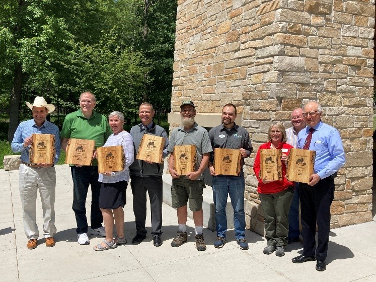 Recipients of the 2022 Invader Crusader Awards stand with their plaques at the annual awards ceremony held at Schmeekle Reserve on June 7, 2022