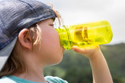 A kid drinking from a water bottle.