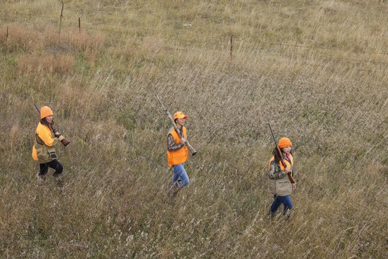 Three female hunters walking