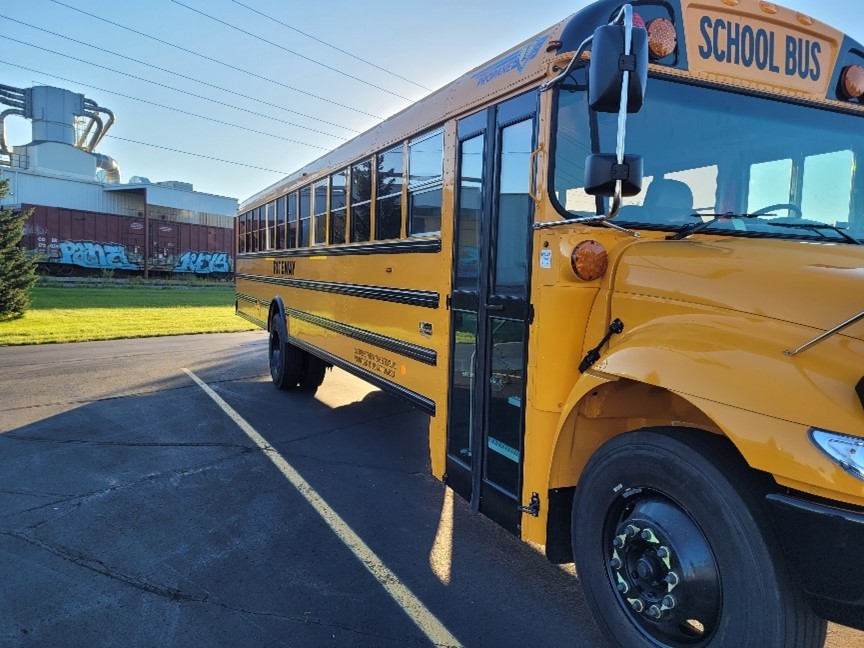 Yellow bus parked in a parking lot