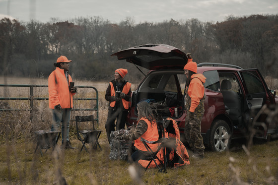 group of male and female hunters gathering at hunting camp