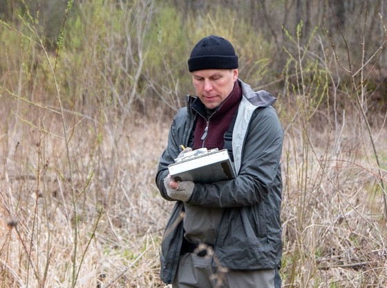 Dr. Matthew Mitro writes down measurements during a survey for one of his trout research projects. 