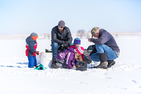 family enjoying ice fishing