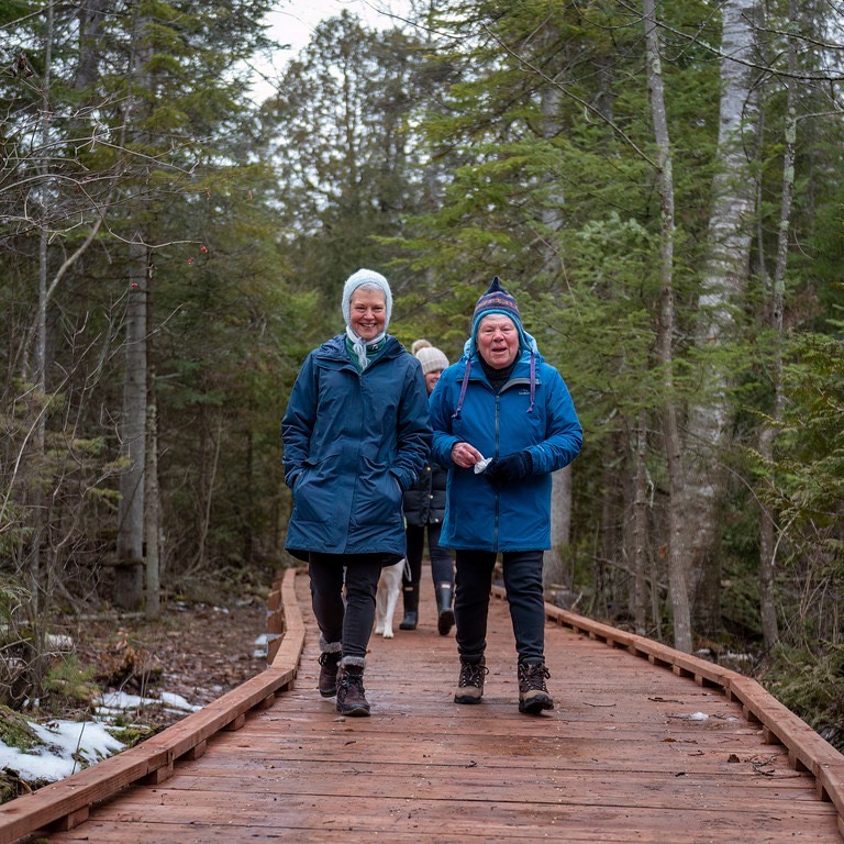 A couple walking along a newly built boardwalk at Newport State Park, courtesy of Stewardship Friends Grant funding.