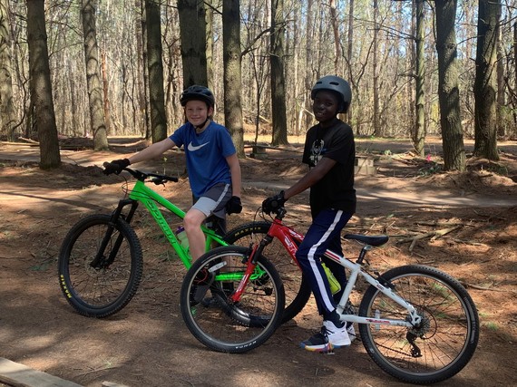 Two boys on bikes in the woods
