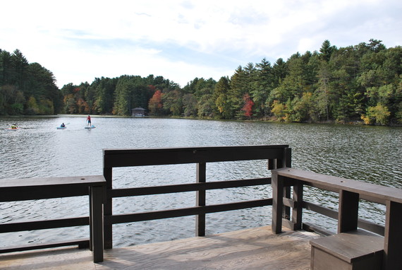 Accessible fishing pier and lake with trees in background