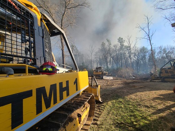 Wisconsin DNR staff drive heavy equipment building the fires line at a recent fire.